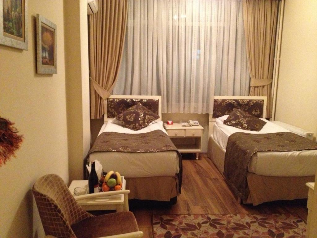 Postel nebo postele na pokoji v ubytování Tac Hotel