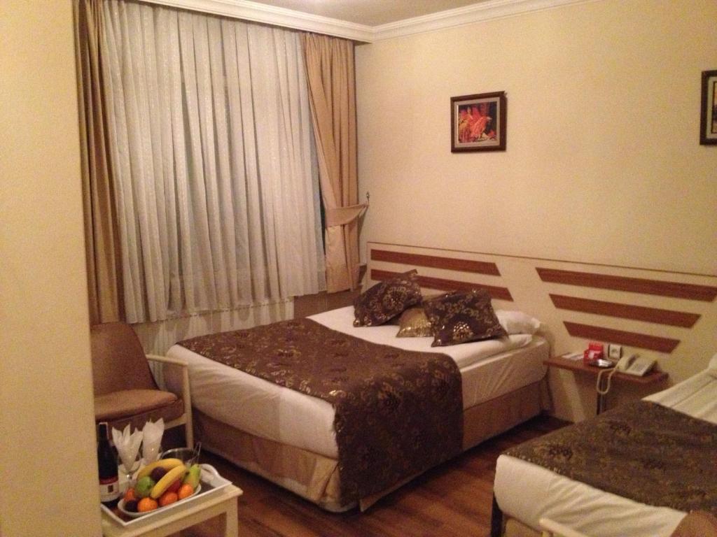 Postel nebo postele na pokoji v ubytování Tac Hotel