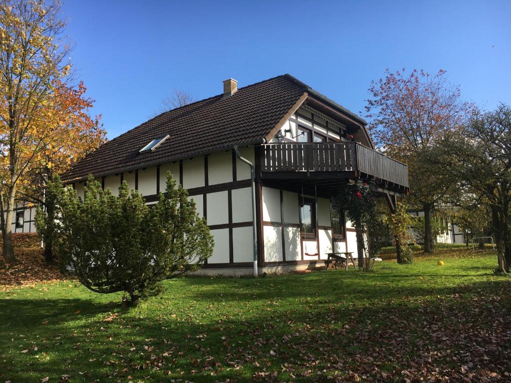 a white and black house with a balcony at Frankenau 237/239 in Frankenau