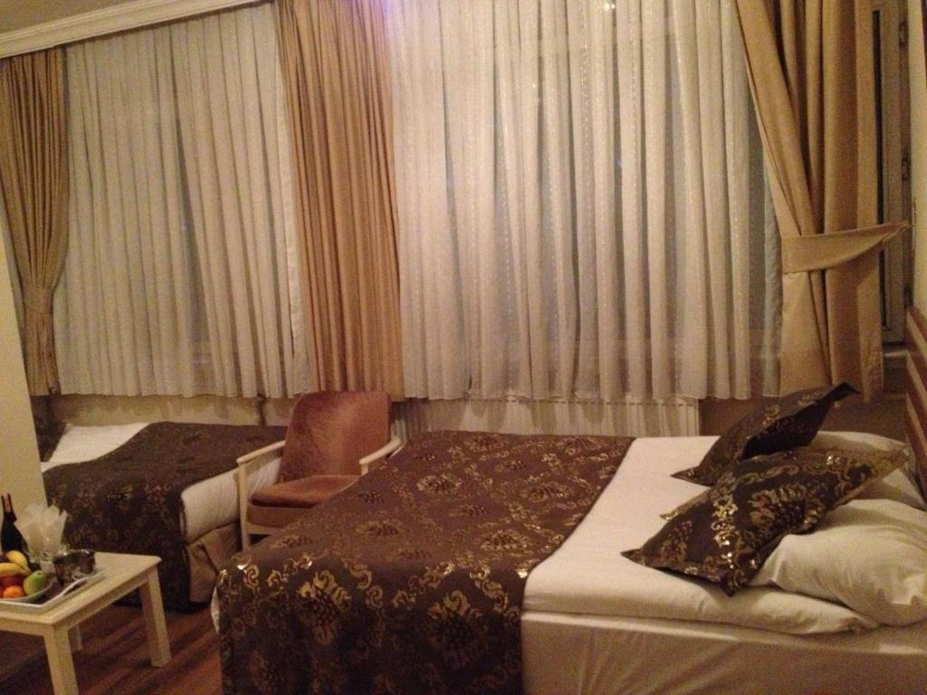 Postel nebo postele na pokoji v ubytování Tac Hotel