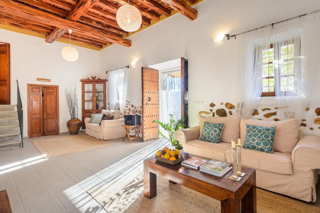 a living room with a couch and a table at Agroturismo rural Can Prats in Sant Carles de Peralta