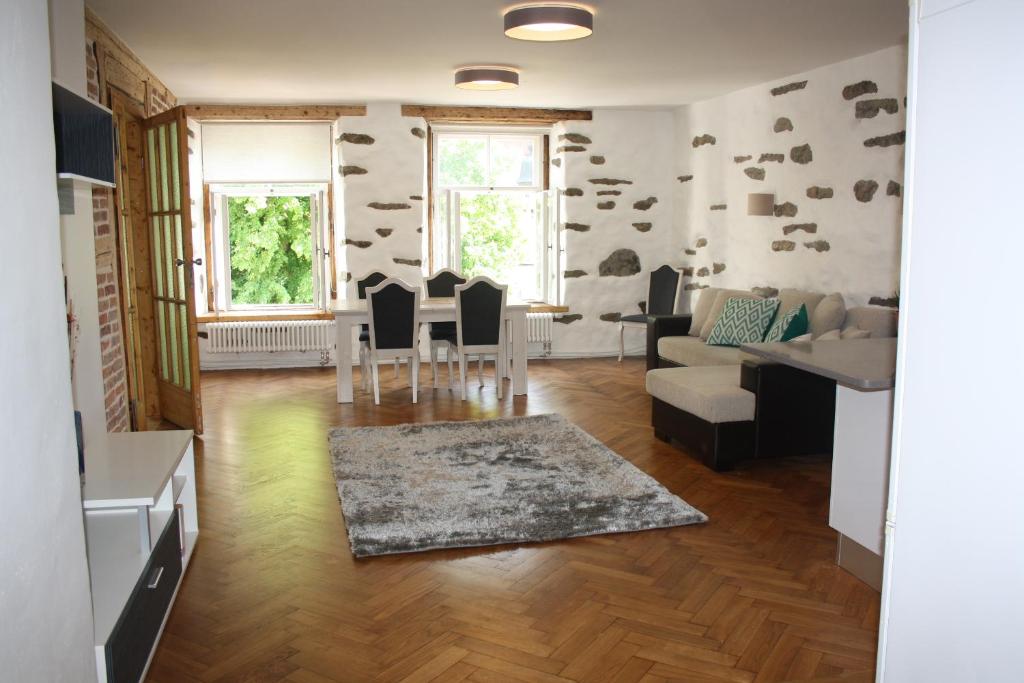 a living room with a table and a couch at Old Town Niguliste Residence in Tallinn