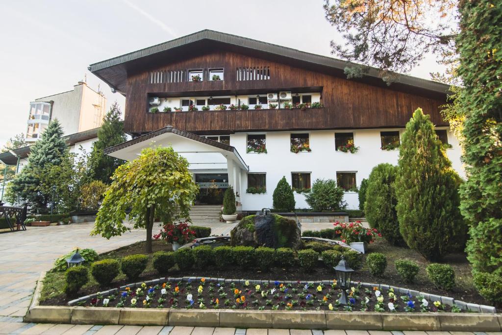 a building with a garden in front of it at boutique hotel Borova Gora in Pirdop