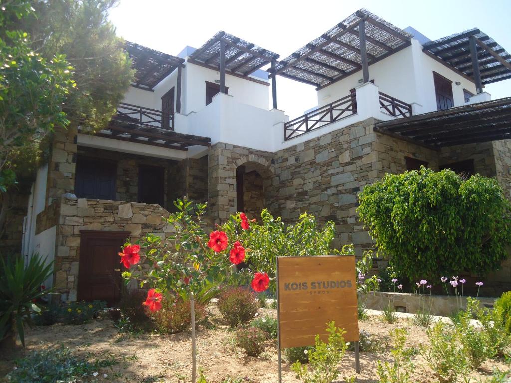 a house with a sign in front of it at Kois Studios in Azolimnos Syros