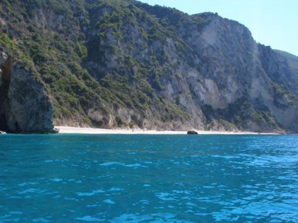 a large body of water with a beach and a mountain at Sea View in Paleokastritsa
