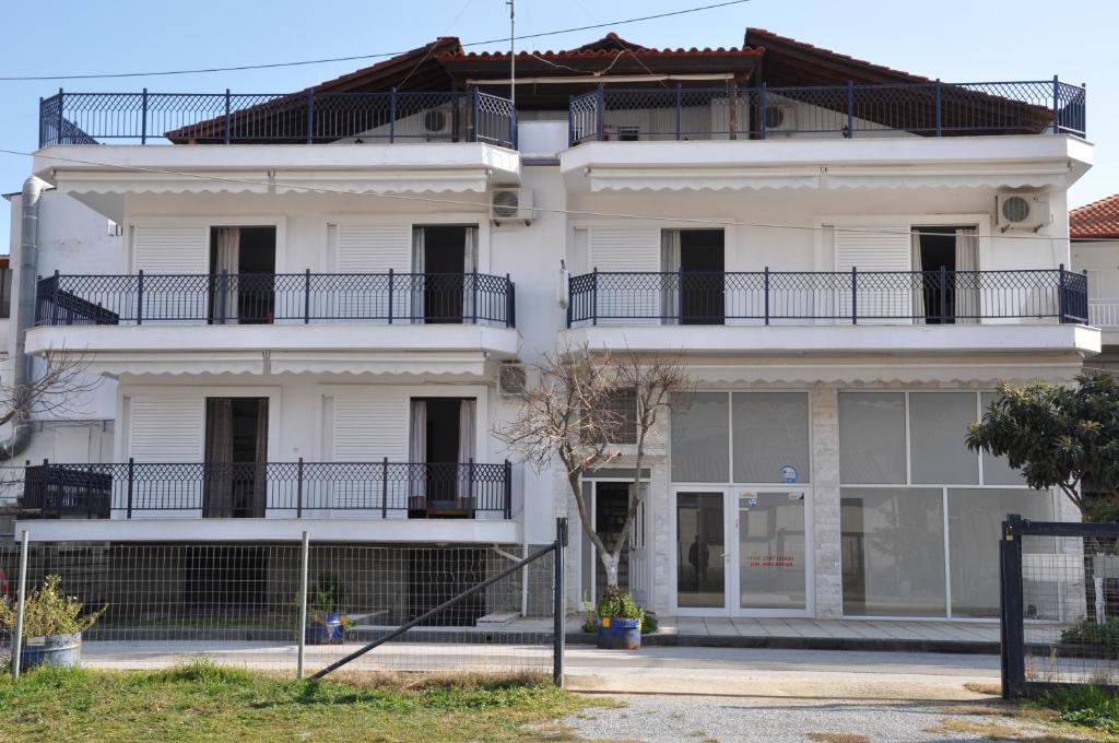 a white building with balconies on top of it at Apartments Stavroula Ηospitality in Nea Vrasna
