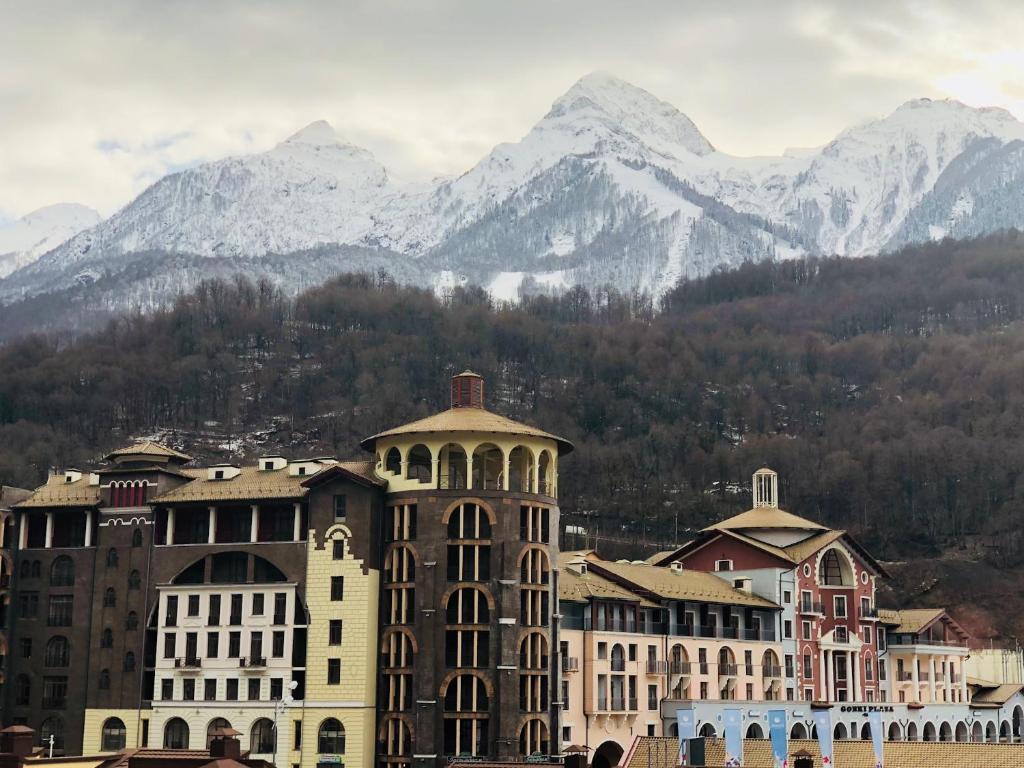 a group of buildings with mountains in the background at 36 Smart Studio MonteRosa in Estosadok