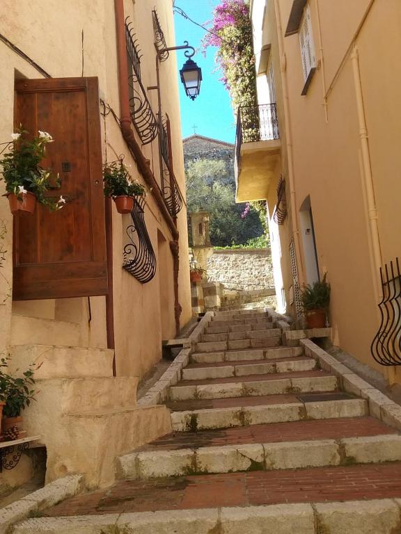 Une allée avec des escaliers, une porte et des fleurs dans l'établissement Studio à 2 pas du Palais, à Cannes