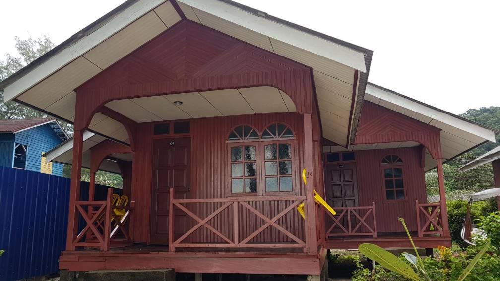 a small red house with a large door at Samudra Beach Chalet in Perhentian Island