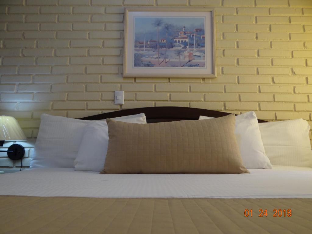 Ένα ή περισσότερα κρεβάτια σε δωμάτιο στο Hotel Mac Arthur