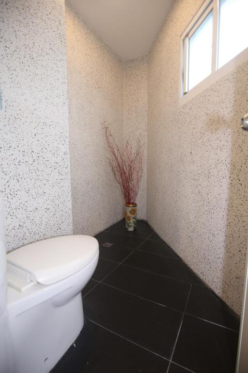 a bathroom with a white toilet and a window at Kenting Waterfront Hotel in Kenting