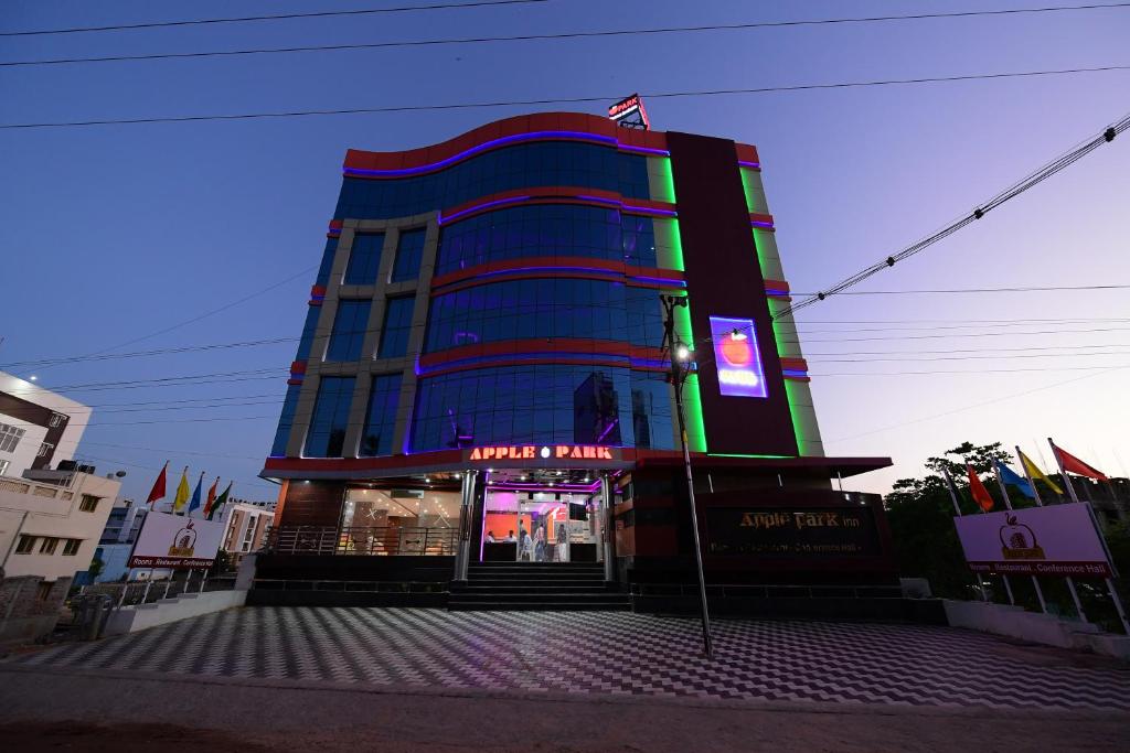 a building with a sign in front of it at Hotel Apple Park Inn in Tiruchchirāppalli