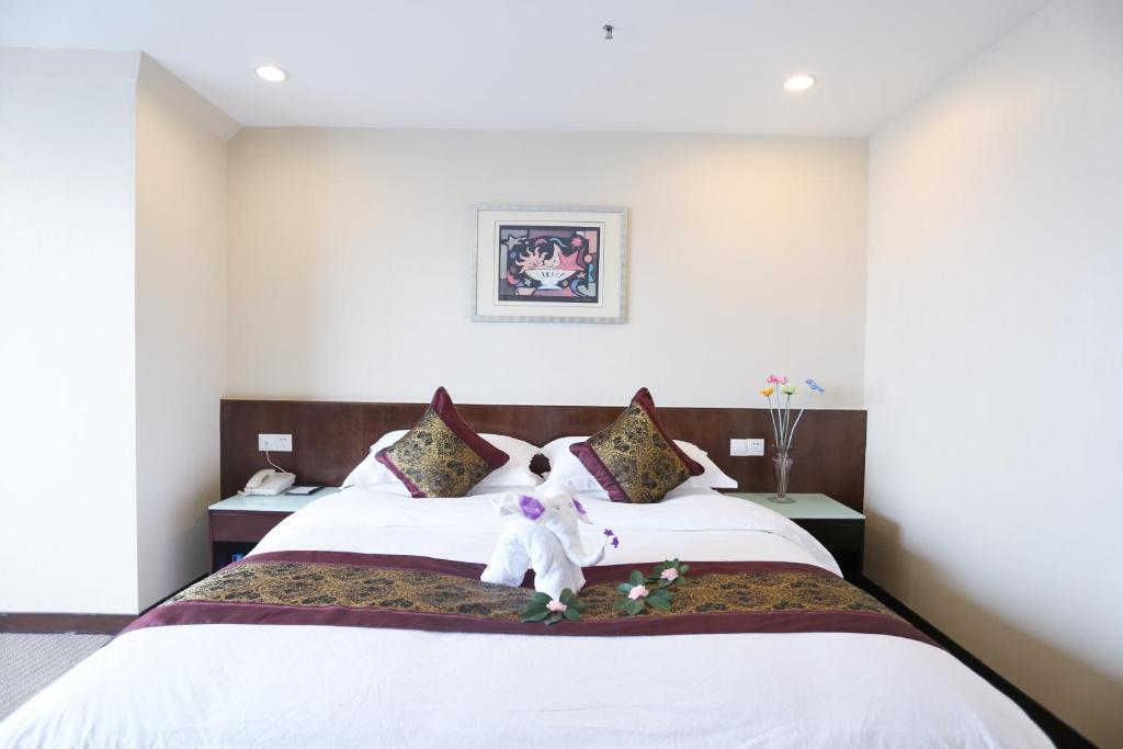 Postel nebo postele na pokoji v ubytování Yihe Hotel Ouzhuang