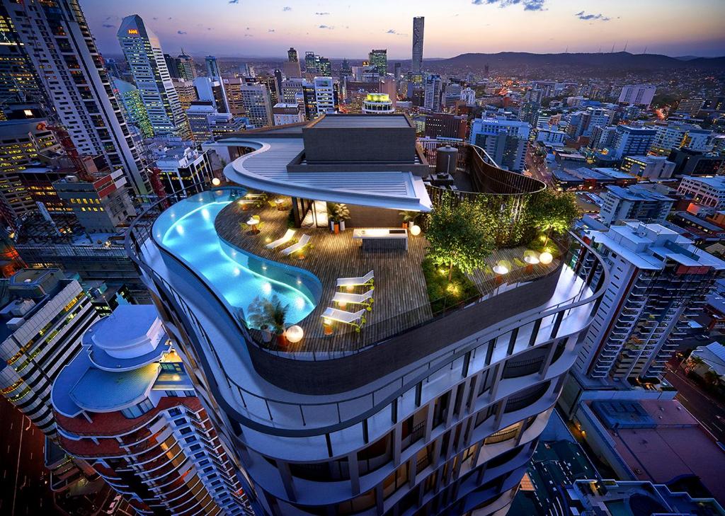 a building with a swimming pool on the top of it at Queen St Residence in Brisbane