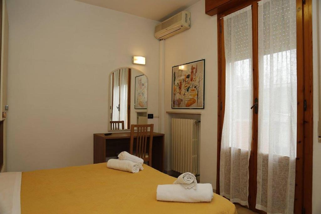 Postel nebo postele na pokoji v ubytování Hotel Villa Dina