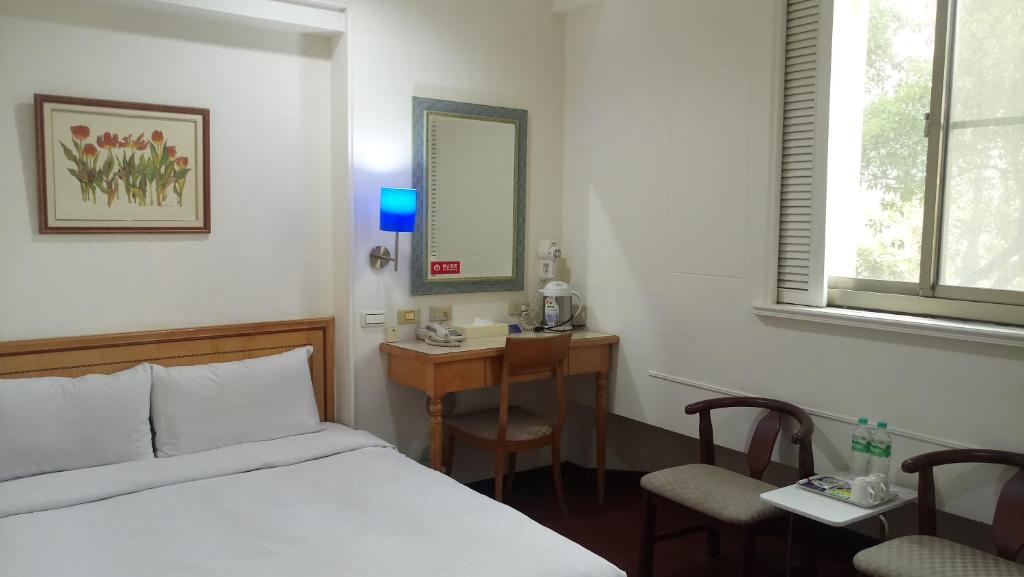Postel nebo postele na pokoji v ubytování 苓雅大飯店 Lingyea Hotel