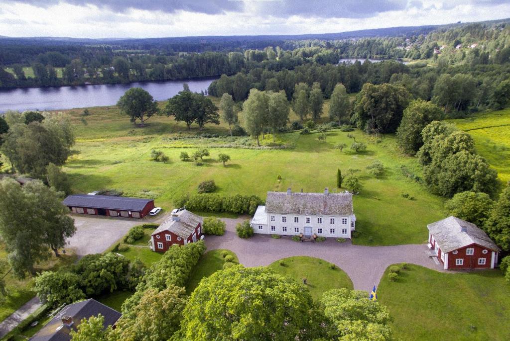 eine Luftansicht eines großen weißen Hauses auf einem grünen Feld in der Unterkunft B&B Kvarntorps Herrgård in Forshaga