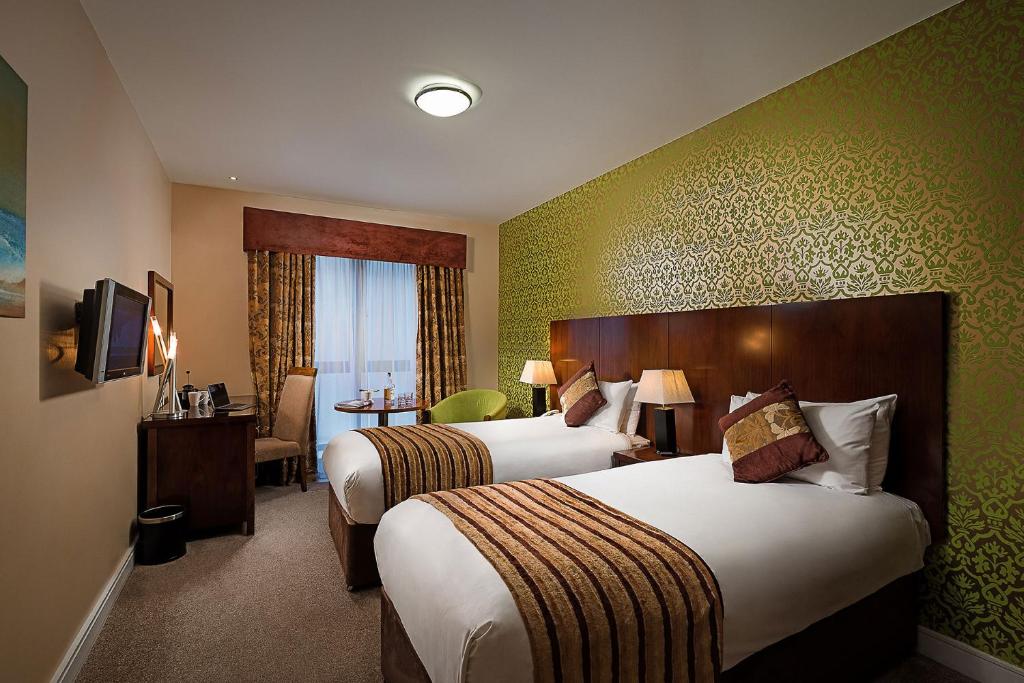 Postel nebo postele na pokoji v ubytování George Limerick Hotel