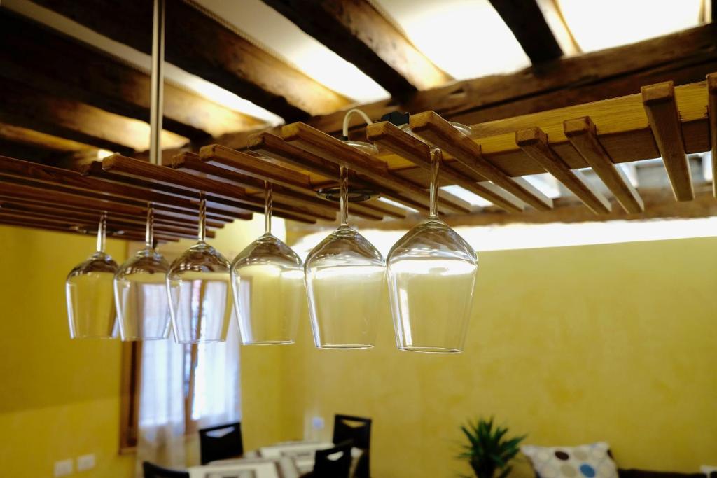 a group of wine glasses hanging from a ceiling at Wendy luxury apartment in Venice