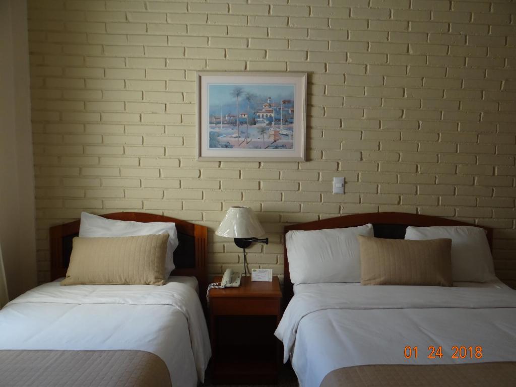 Ένα ή περισσότερα κρεβάτια σε δωμάτιο στο Hotel Mac Arthur