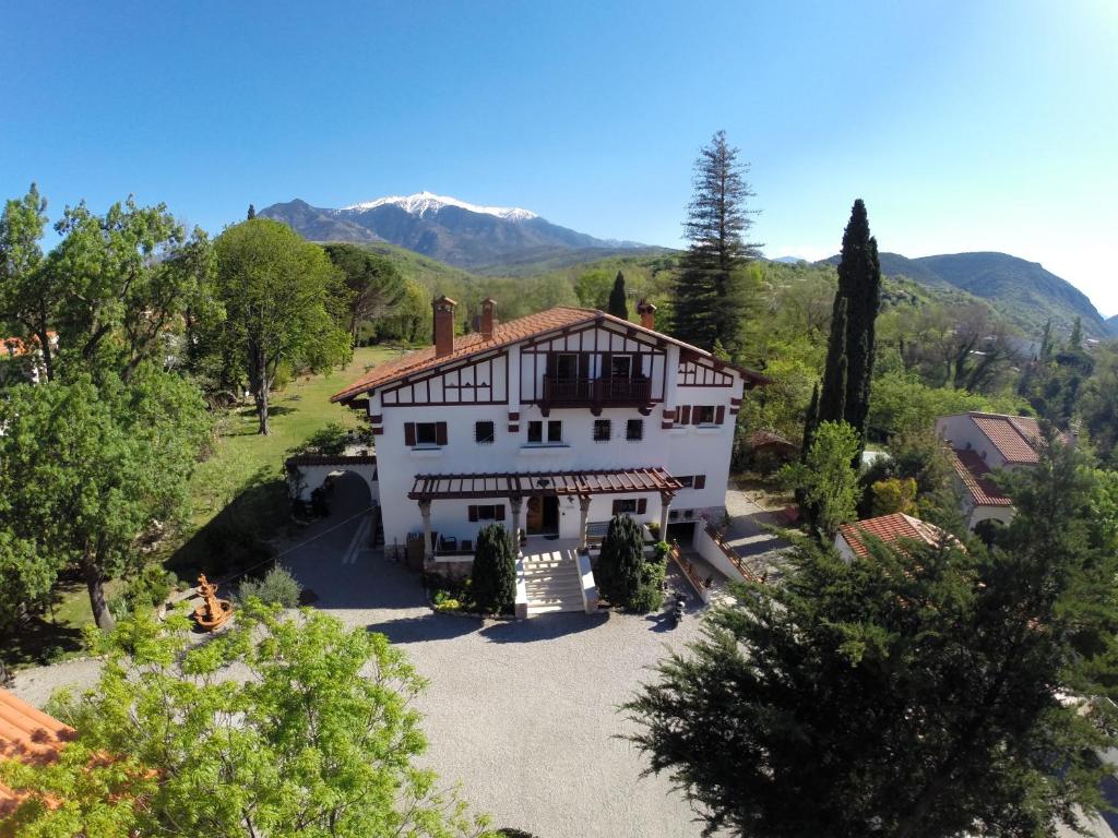 an aerial view of a house with mountains in the background at La Villa du Parc in Prades
