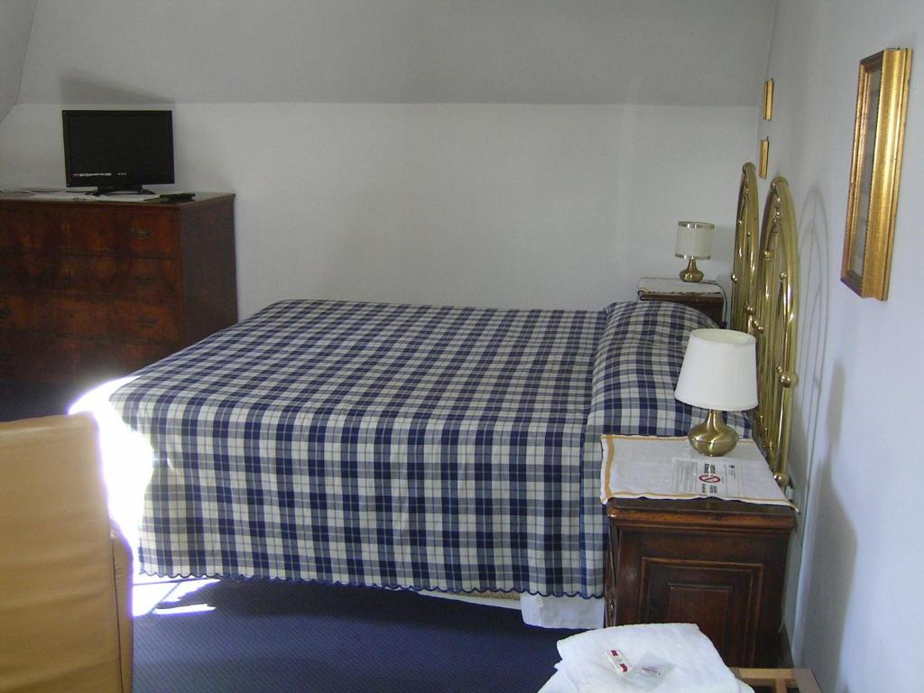 Postel nebo postele na pokoji v ubytování Albergo San Cristoforo