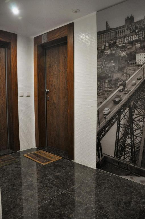 a door in a room with a picture of a bridge at PicPorto Apartment in Porto
