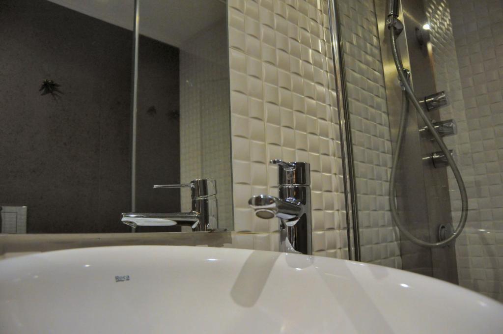 a bathroom with a tub and a shower and a sink at PicPorto Apartment in Porto