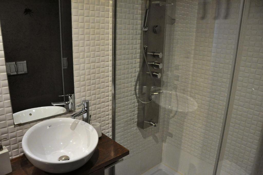 a bathroom with a sink and a glass shower at PicPorto Apartment in Porto