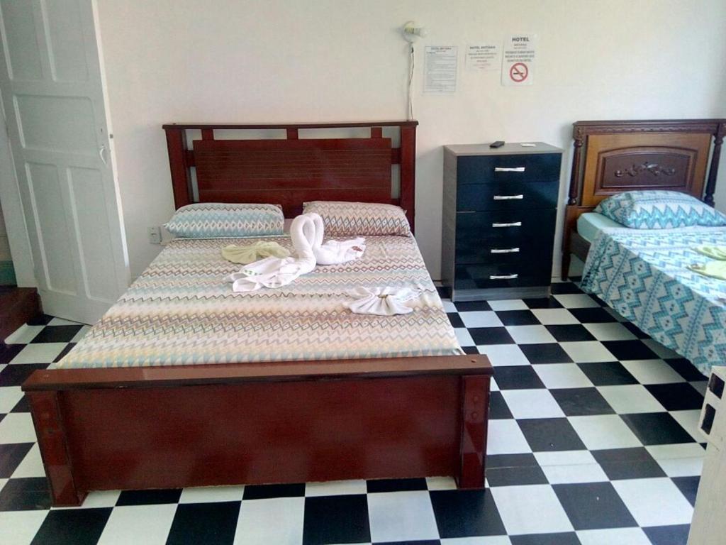 Postel nebo postele na pokoji v ubytování Britânia Hotel