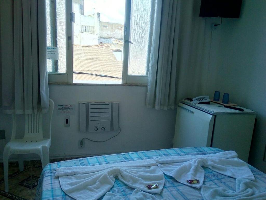 Postel nebo postele na pokoji v ubytování Britânia Hotel