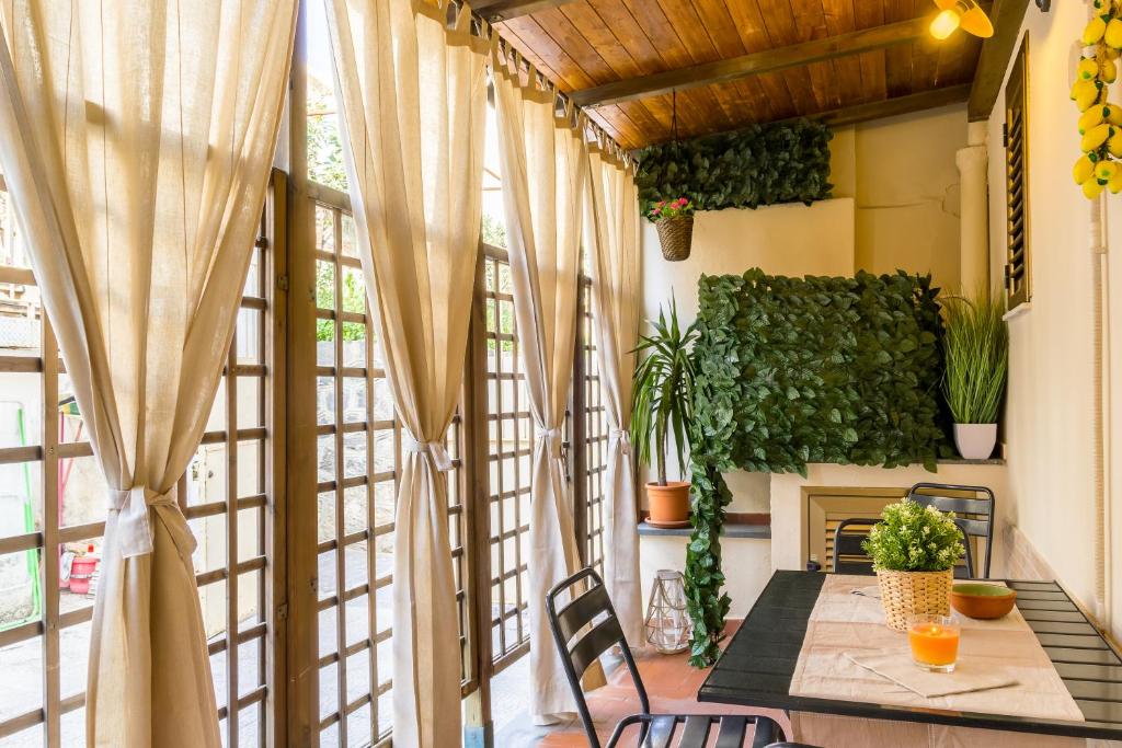 a balcony with a table and chairs and a fireplace at Casa Martina in Giardini Naxos