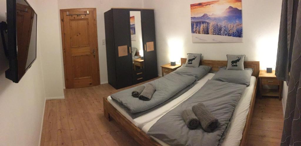 a bedroom with two twin beds and a mirror at Apartment Hermine in Jochberg