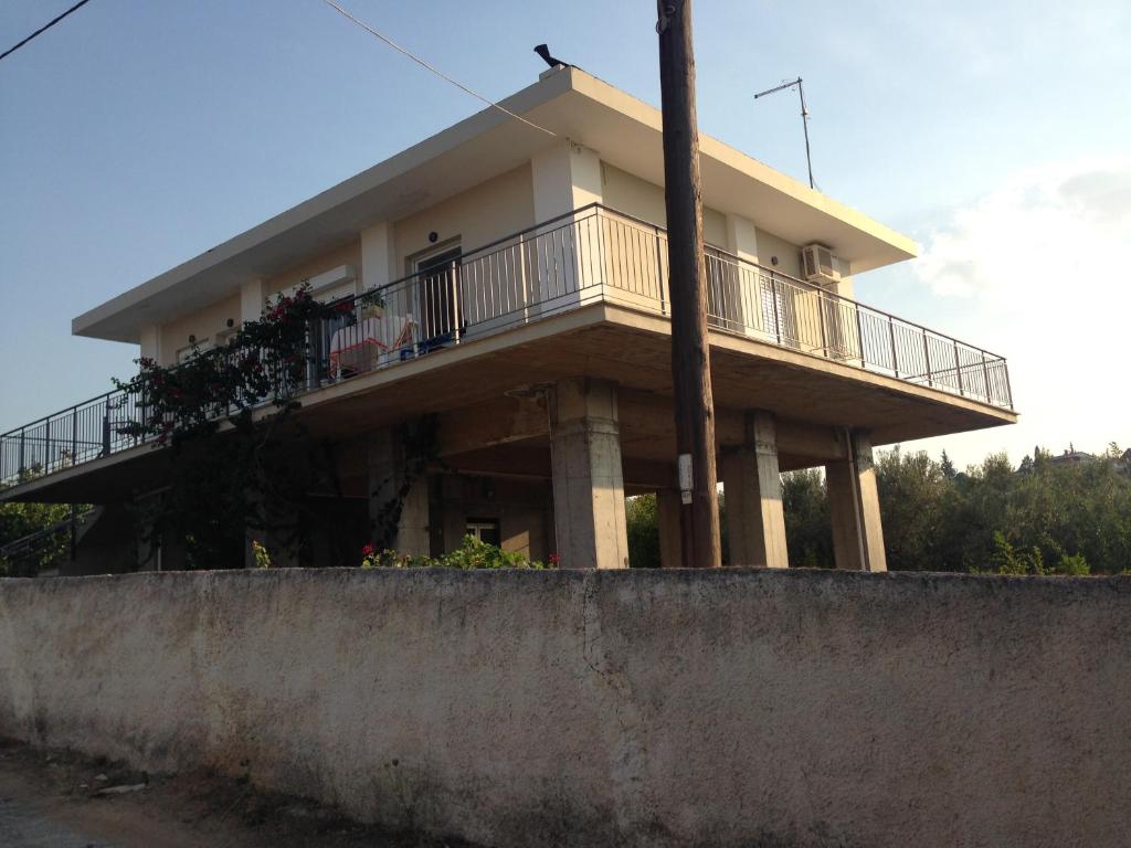 a house with a balcony on top of a wall at Dimitri's house in Dhílesi