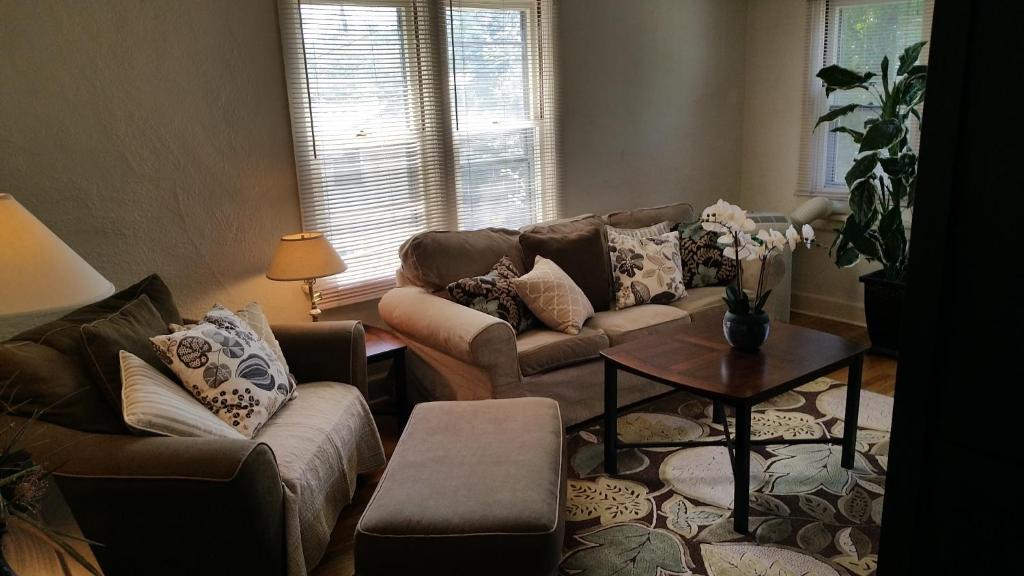 a living room with two couches and a table at ❤️ Lovely Smart Craftsman King HDTV WIFI AC Yard in Klamath Falls