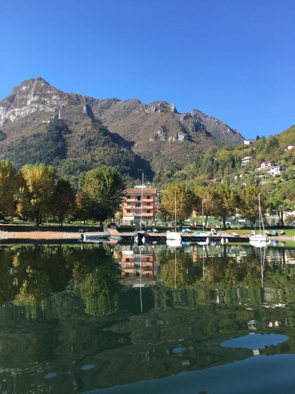 a large body of water with a mountain in the background at Albergo al lago in Anfo
