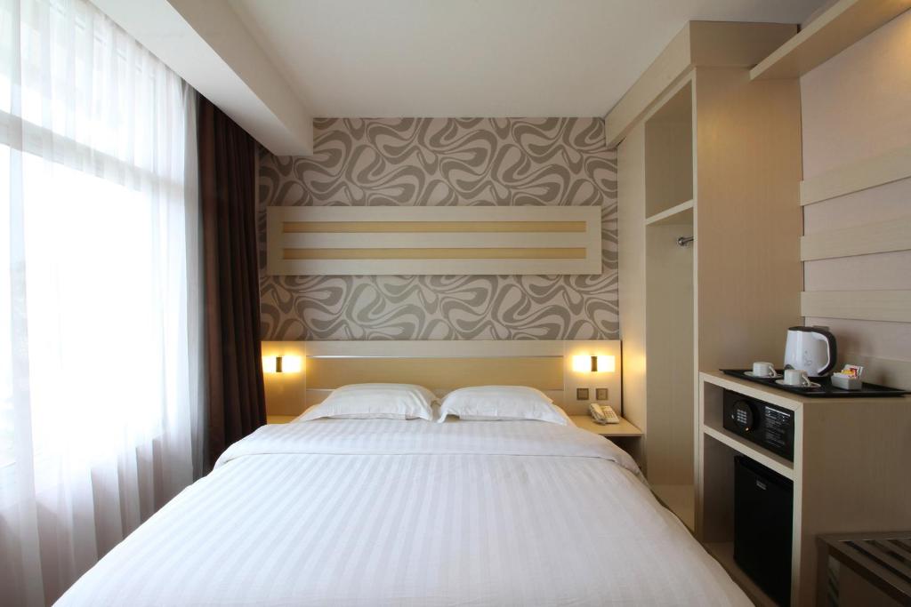 Postel nebo postele na pokoji v ubytování Classie Hotel