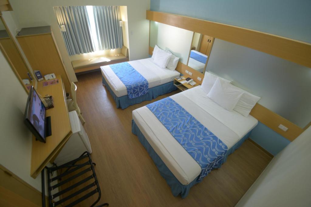 Postel nebo postele na pokoji v ubytování Microtel by Wyndham Davao