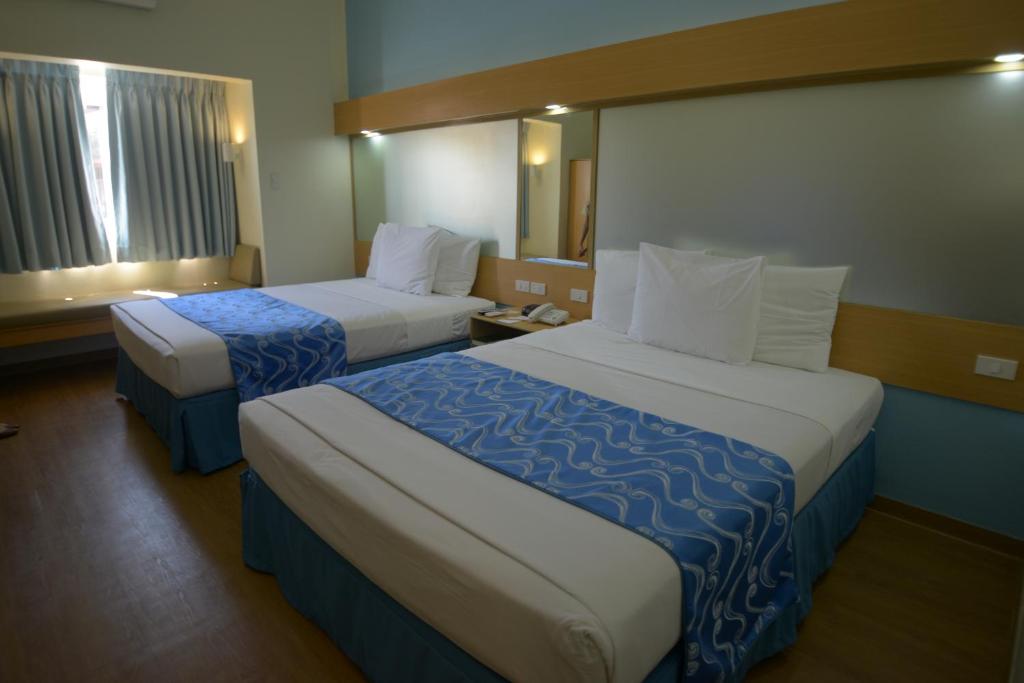 Postel nebo postele na pokoji v ubytování Microtel by Wyndham Davao