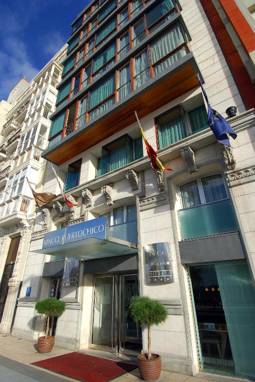 a building with flags on the front of it at Vincci Puertochico in Santander