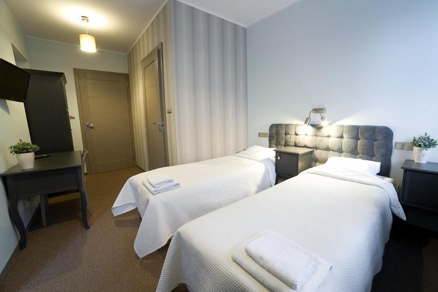 Postel nebo postele na pokoji v ubytování Avalis Apartamenty