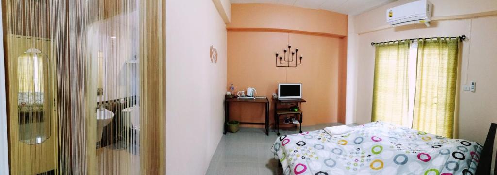 Postel nebo postele na pokoji v ubytování T.M. Home, Hatyai