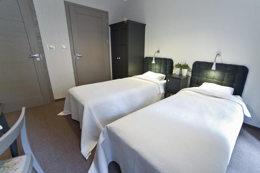 Postel nebo postele na pokoji v ubytování Avalis Apartamenty