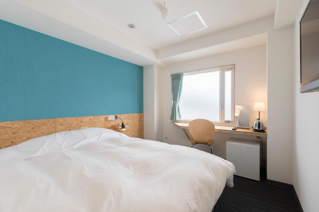 Postel nebo postele na pokoji v ubytování Nikko Station Hotel 2