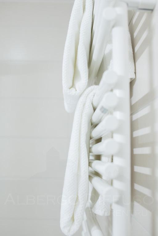 a stack of white towels hanging on a rack at Albergo Diffuso Porrentruy in Porrentruy