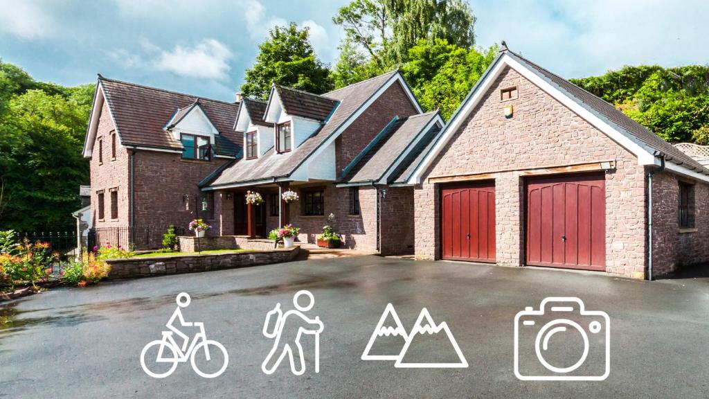 a house with a driveway with drawings on it at Mill Lodge-Brecon Beacons in Gilwern