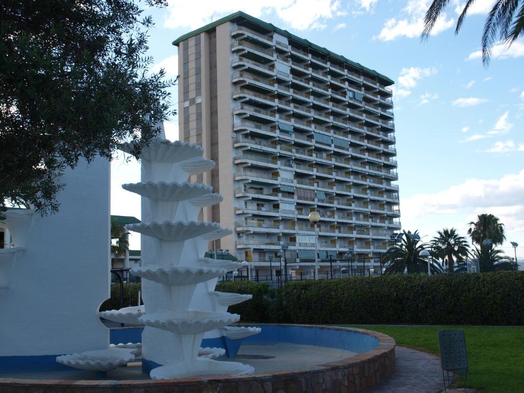 a water fountain in front of a tall building at Apt. New Holiday Valencia Beach in El Puig
