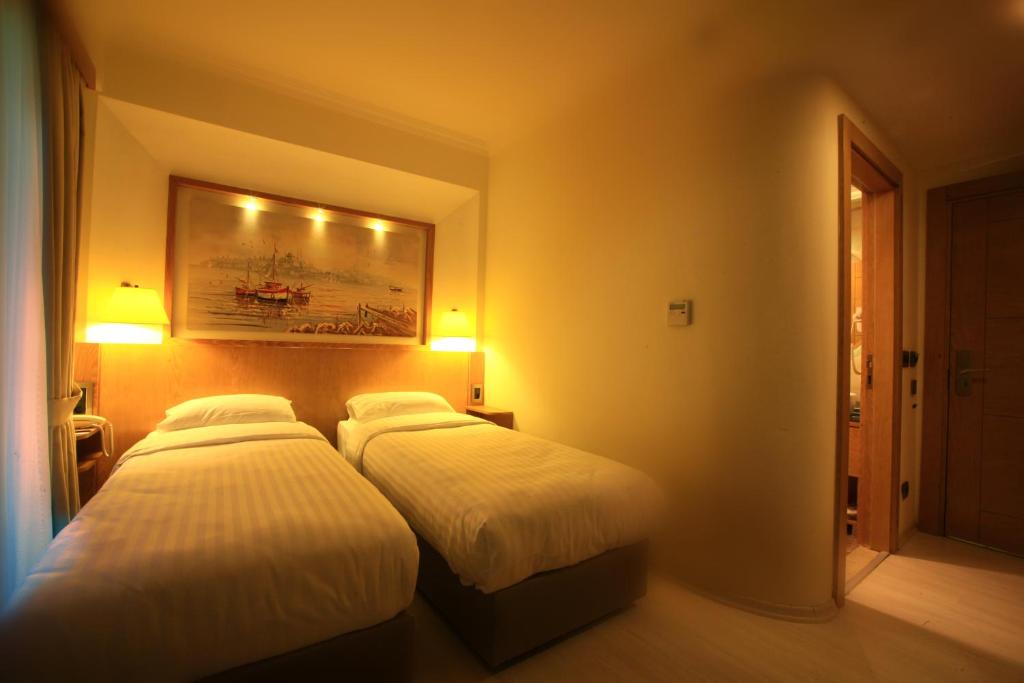Postel nebo postele na pokoji v ubytování Beyoglu MLS Hotel