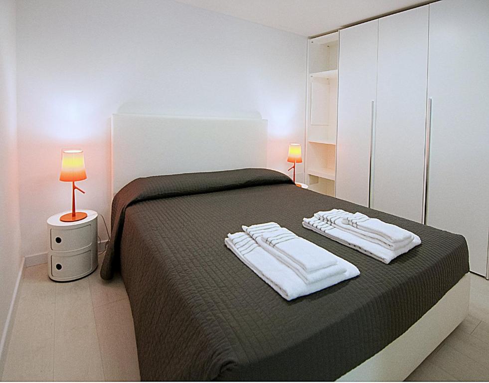 a bedroom with a bed with two towels on it at BB Hotels Aparthotel Desuite in Milan