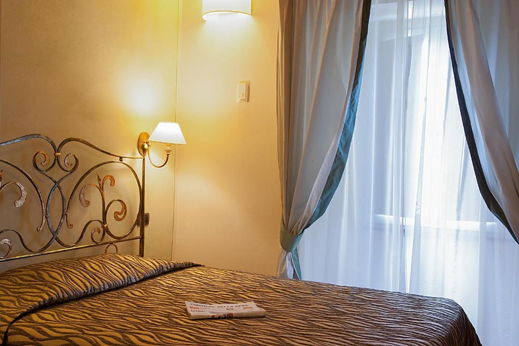 Postel nebo postele na pokoji v ubytování Borgo Sant'ippolito Country Hotel